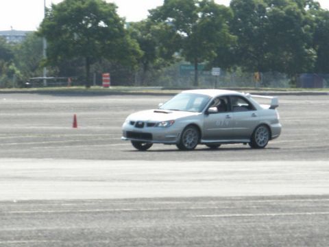2001 Mercury Grand Marquis - A silver Subaru Impreza WRX STI is seen on a track, possibly during a timed event or race.