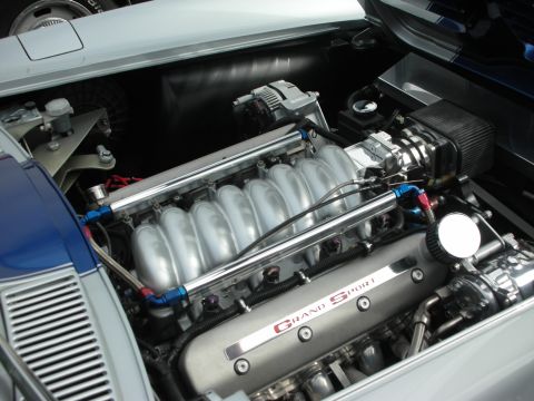 1998 Ford Crown Victoria - Close-up view of a modified V8 engine bay, showing custom intake and valve covers.