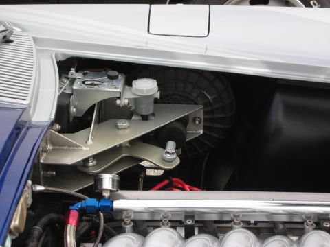 1998 Ford Crown Victoria - Close-up of a car's engine bay, focusing on the brake fluid reservoir and fan assembly.
