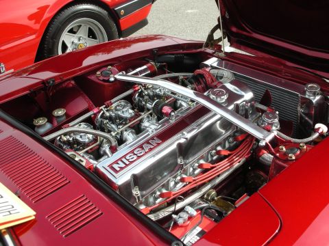 1998 Ford Crown Victoria - The engine bay of a classic Nissan sports car is meticulously detailed with chrome accents and vibrant red components.