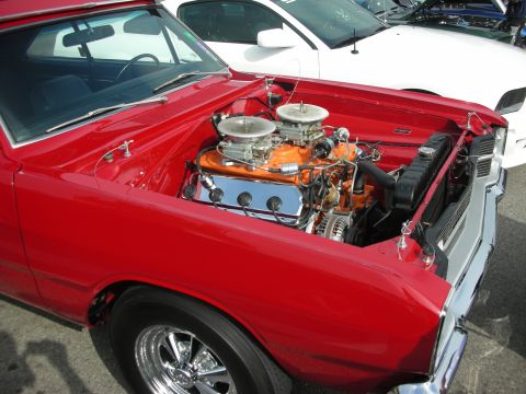 1998 Ford Crown Victoria - Close-up of a V8 engine in a red classic car, with another vehicle visible in the background.