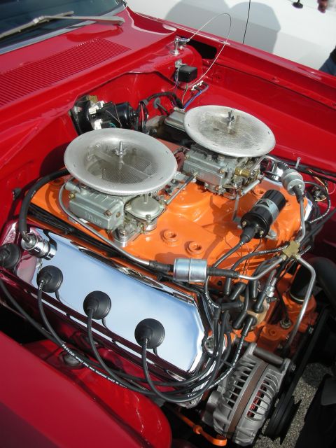 1998 Ford Crown Victoria - Close-up view of a V8 engine dual carburetors and chrome valve covers.