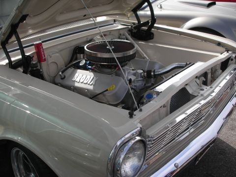 1998 Ford Crown Victoria - The engine bay of a classic car is open, revealing a Brodix engine and a red can of Coca-Cola.