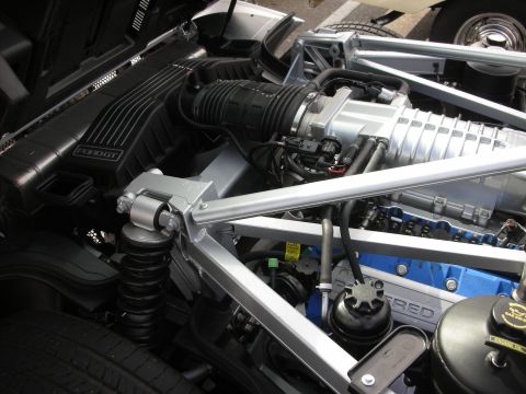 1998 Ford Crown Victoria - Close-up of the engine bay in a Ford GT, showing the supercharger and intake system.