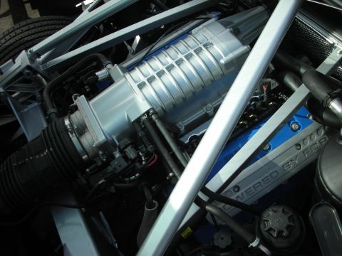 1998 Ford Crown Victoria - The engine bay features a prominent supercharger and 'POWERED BY FORD' branding on the valve cover.