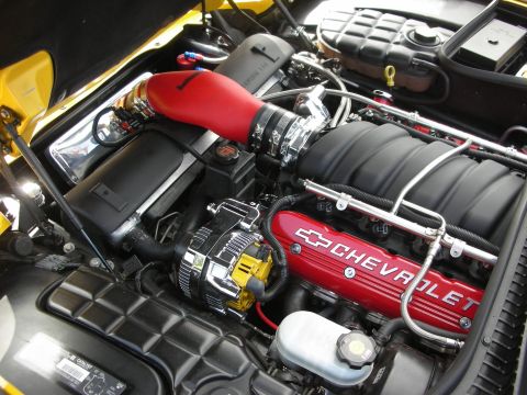 1998 Ford Crown Victoria - The engine bay features red Chevrolet valve covers and a red cold air intake system.