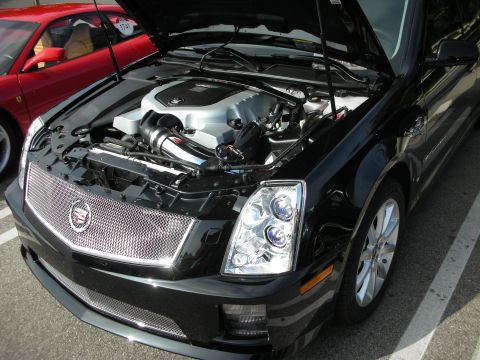 1998 Ford Crown Victoria - Black Cadillac CTS-V at a car meet, hood open to display the engine.
