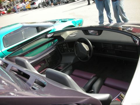 1998 Ford Crown Victoria - Interior of a purple convertible is visible, parked next to a teal car at a meet.
