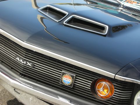 1998 Ford Crown Victoria - Close-up of the front grille of a black AMX, chrome detailing and an orange turn signal light.
