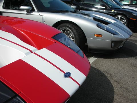 1998 Ford Crown Victoria - Two Ford GT sports cars parked side-by-side, one red and white, the other silver.