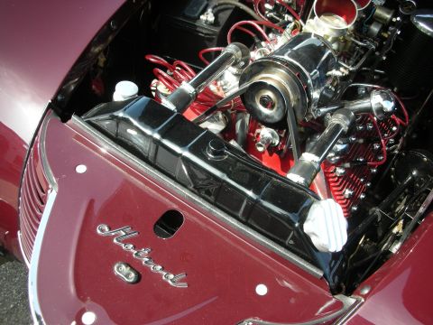 1998 Ford Crown Victoria - Close-up view of a custom engine bay chrome components and red accents, with a "Hotrod" emblem on the fender.