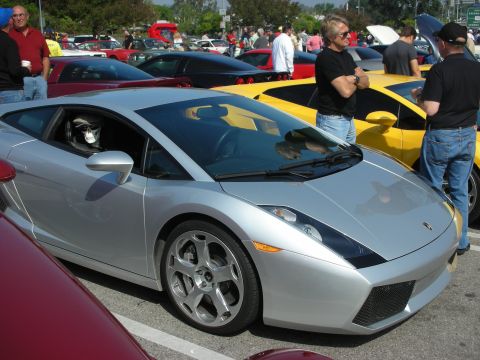 1998 Ford Crown Victoria - Several cars are gathered at an outdoor event, including a silver Lamborghini Gallardo.
