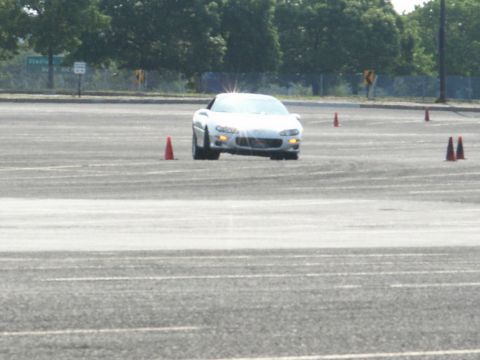 2001 Mercury Grand Marquis - White Chevrolet Camaro navigating a course marked by orange cones on a sunny day.
