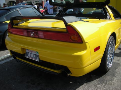 1998 Ford Crown Victoria - Rear view of a yellow Honda NSX sports car with a large spoiler and custom license plate.