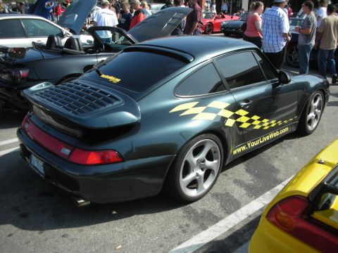 1998 Ford Crown Victoria - Porsche 911 Carrera at a car meet, with graphics on the door and rear quarter panel.