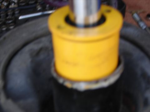 1992 Ford Taurus - A close-up view of a yellow suspension component, possibly a shock absorber bushing, is shown in detail.