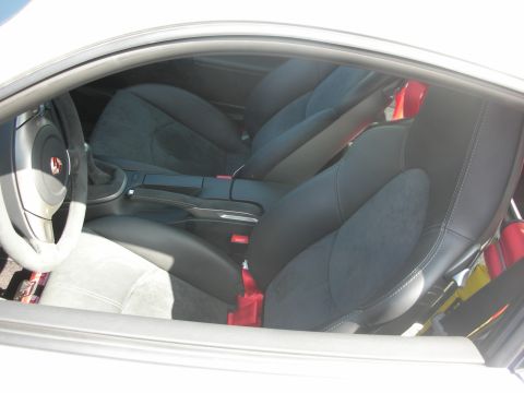 1998 Ford Crown Victoria - Interior view of a car showing black seats and red seatbelts.