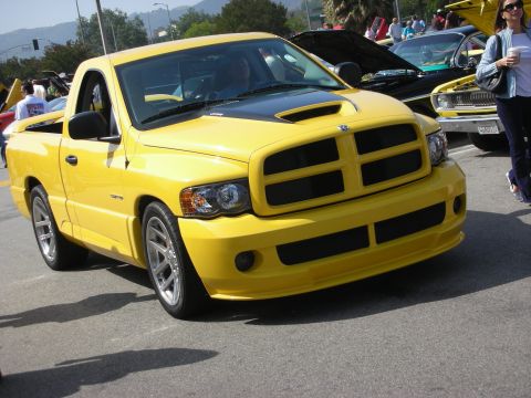 1998 Ford Crown Victoria - Yellow Dodge Ram SRT-10 pickup truck at a car meet.