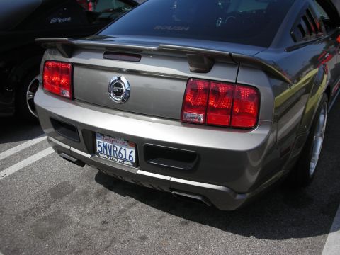 1998 Ford Crown Victoria - Gray Ford Mustang GT parked next to another vehicle.