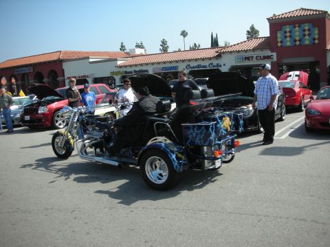 1998 Ford Crown Victoria - Custom trike with lightning graphics at a car meet.