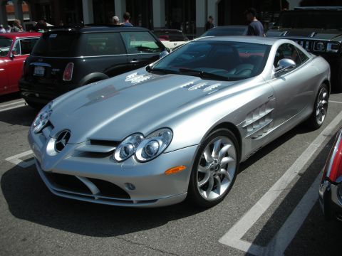 1998 Ford Crown Victoria - Silver Mercedes-Benz SLR McLaren parked next to other vehicles at an outdoor gathering.