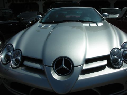 1998 Ford Crown Victoria - A silver Mercedes-Benz SLR McLaren is parked in front of other vehicles.