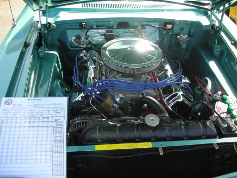 1998 Ford Crown Victoria - Engine bay detail of a classic car, with a technical document displayed.