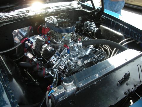 1998 Ford Crown Victoria - Close-up view of a customized V8 engine bay with polished chrome components and a blue air filter.