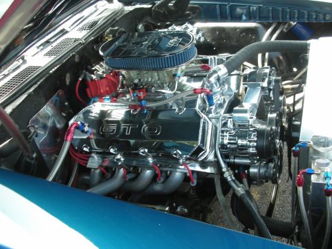 1998 Ford Crown Victoria - Customized engine bay chrome components and GTO branding on the valve covers.