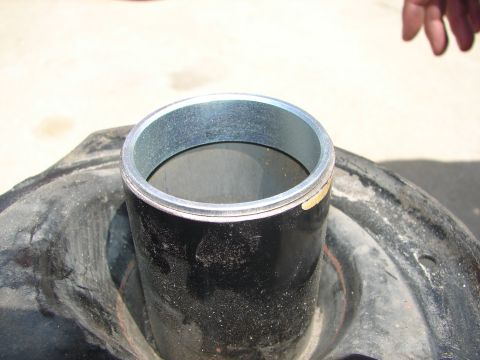 1992 Ford Taurus - A shock absorber assembly is shown, a metal sleeve and part of a tire. The registry label suggests a 1992 Ford Taurus, but this is unconfir…