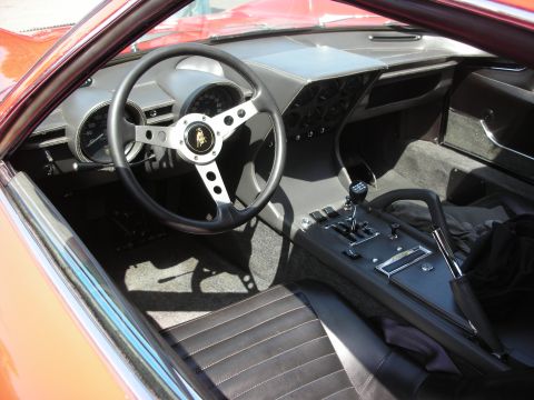 1998 Ford Crown Victoria - Interior view of a Lamborghini Miura, showing the dashboard, steering wheel, and center console.