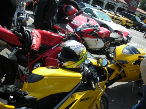 1998 Ford Crown Victoria - A collection of Ducati motorcycles, including yellow and red models, are gathered for a meet-up.