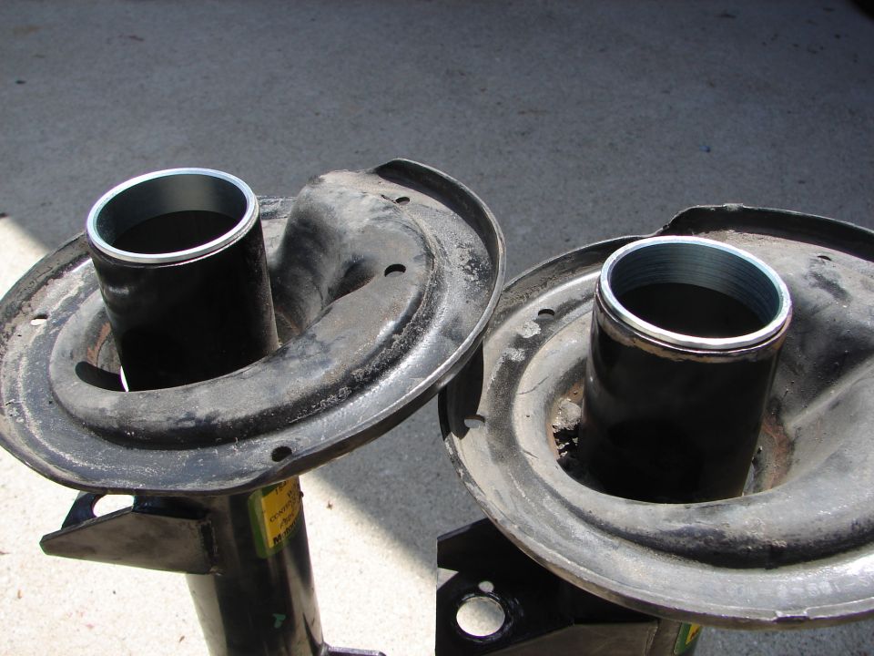 Two car shock absorber assemblies, one on the left and one on the right