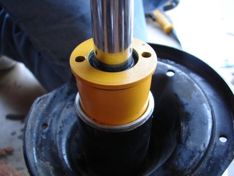 1992 Ford Taurus - Close-up of a shock absorber assembly, likely during a repair or installation process.