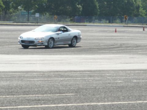 2001 Mercury Grand Marquis - Silver sports coupe navigates an asphalt course with cones visible.