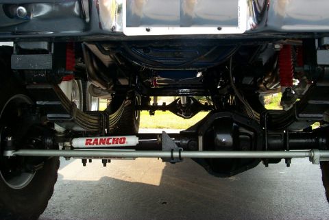 1979 Ford F-250 - The underside of a truck shows its suspension components and drivetrain.