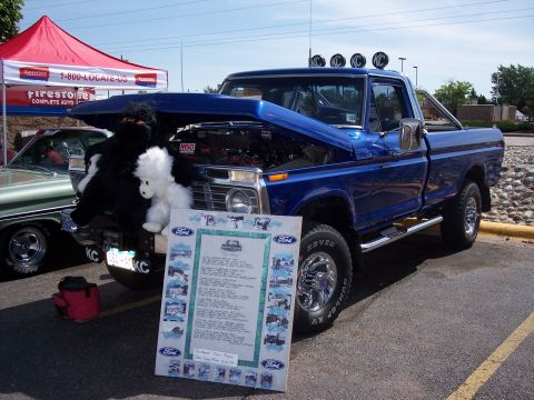 1972 Ford Ranchero - Blue Ford pickup truck on display, hood open, with a detailed informational board.