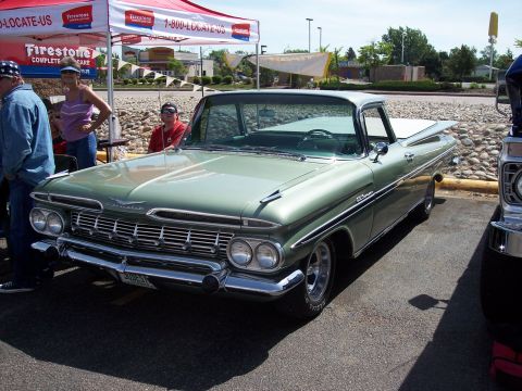1972 Ford Ranchero - Green 1959 Chevrolet El Camino on display at an outdoor event.