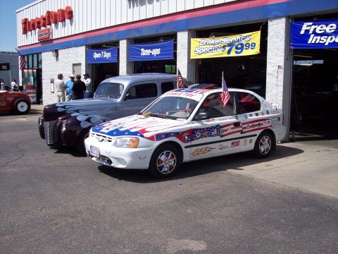 1972 Ford Ranchero - A decorated Hyundai Accent is parked outside a Firestone service center.