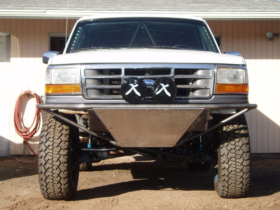 Lifted white Ford Bronco front view with tube bumper and lights