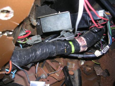 1975 Ford Ranchero - A close-up view shows a complex vehicle wiring harness with various wires and connectors.