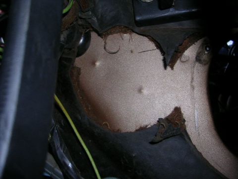 1975 Ford Ranchero - Interior view of a damaged car panel with exposed wiring and metal.