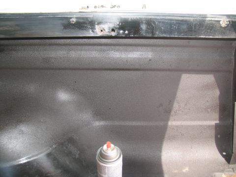 1978 Ford Bronco - Spray can rests on a textured interior panel, likely being treated for sound deadening.