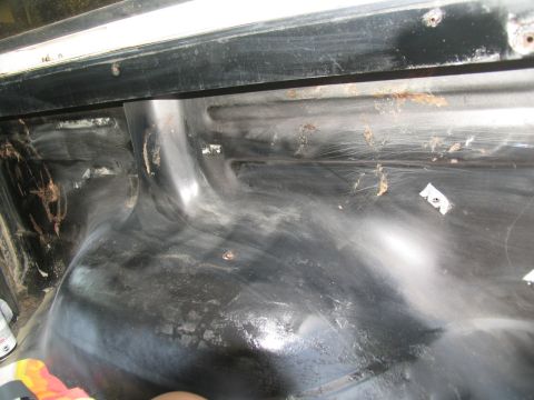 1978 Ford Bronco - The interior cargo area of a vehicle, possibly prepped for a new coating or paint application.