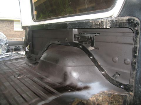 1978 Ford Bronco - Interior view of a 1978 Ford Bronco during tub priming, focusing on the bed and wheel well area.