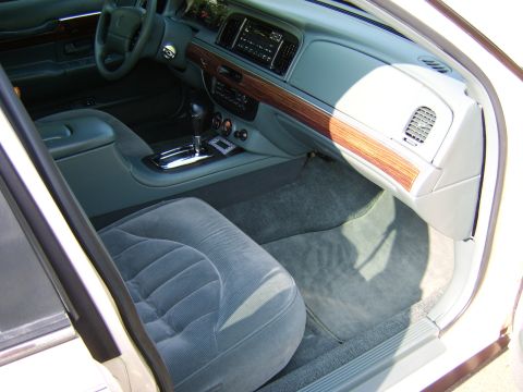 1996 Mercury Grand Marquis - Interior view of a 1996 Mercury Grand Marquis, highlighting its velour seats and wood grain dashboard trim.