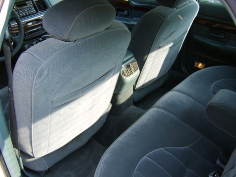 1996 Mercury Grand Marquis - Interior view of a car's back seat and dashboard, showing the upholstery and climate controls.