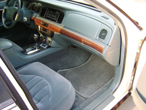 1996 Mercury Grand Marquis - The interior of a 1996 Mercury Grand Marquis features wood grain trim and comfortable gray seating.
