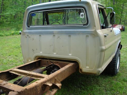 1967 Ford F-250 - The rear of a 1967 Ford F-250 truck is shown, with its chassis exposed and showing signs of rust.