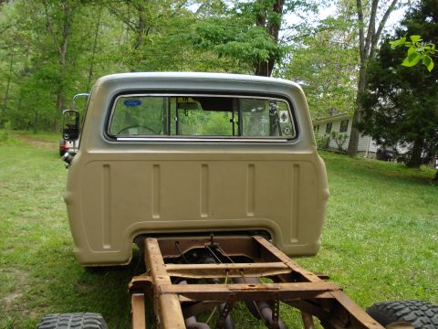 1967 Ford F-250 - The rear of a 1967 Ford F-250 pickup truck cab and chassis is shown, with a tan body and gray roof.